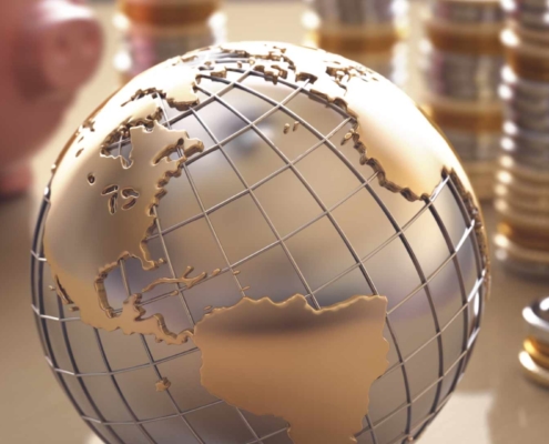 Golden globe and coins symbolizing international taxation and financial planning.